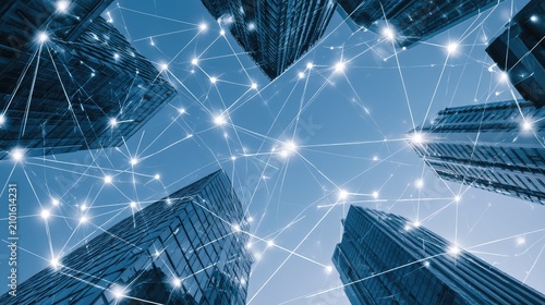 Connecting skyscrapers in a digital network against a clear blue sky