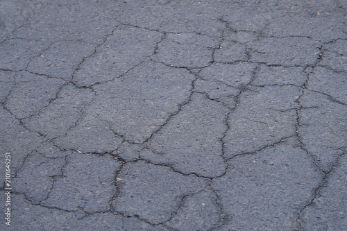 Fotografie Background photo of old gray asphalt with cracks on surface due to worn condition