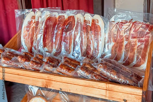Fototapeta na wymiar Various cold cuts including ham and salami sausages in vacuum packaging, displaying food preservation and delicatessen products