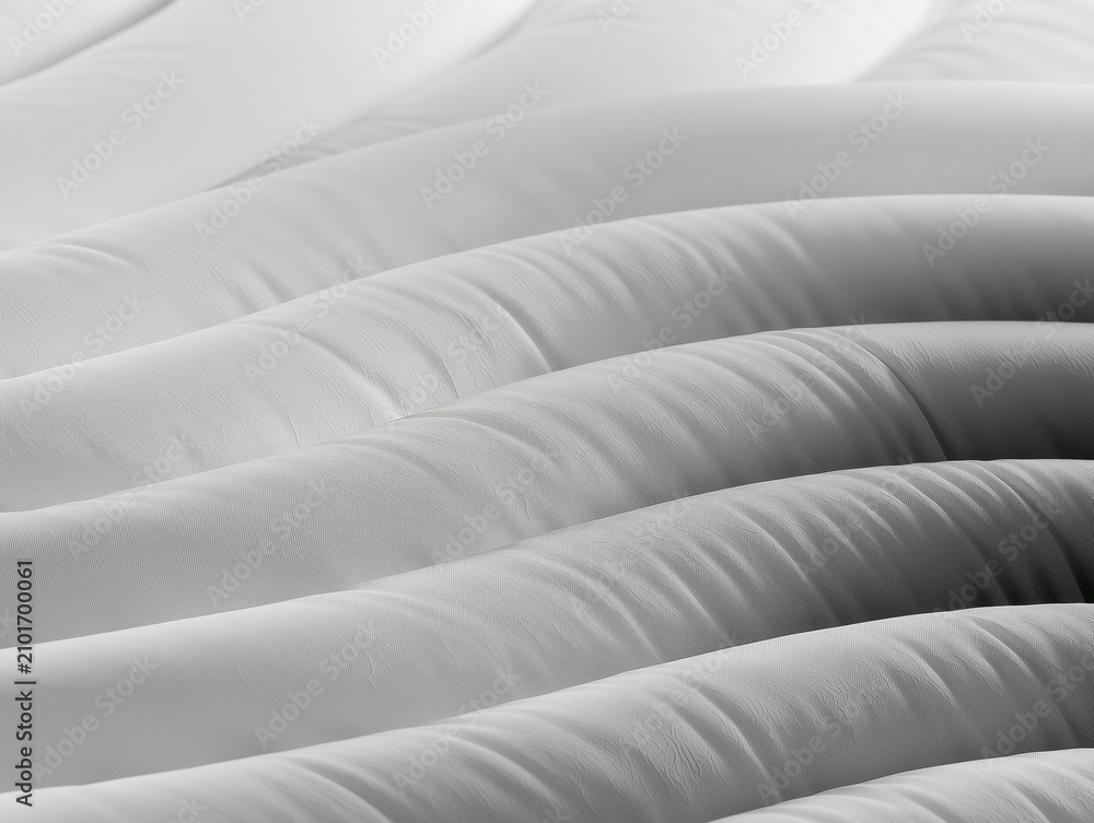Obraz premium Abstract Close Up Architectural View of White Rippling Padded Fabric Ridges Minimalist Futuristic Wave Textures and Monochromatic Pattern Design