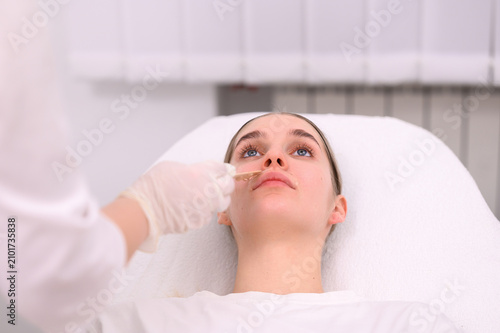 Fotografie Young woman receiving facial treatment with conductive gel before cosmetic laser