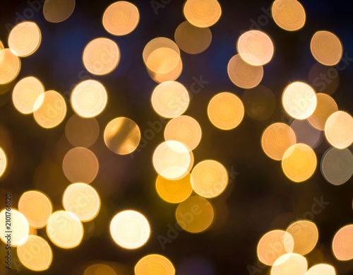 Soft, golden, out-of-focus circular lights on a dark background