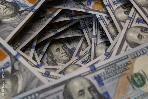Benjamin Franklin portrait inside a swirling tunnel of US one hundred dollar bills