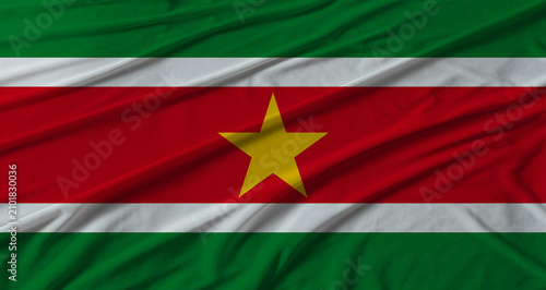 фотографія Suriname flag waving. Flag of Suriname with cloth texture