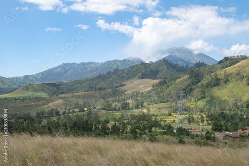 Breathtaking Panoramic View of Majestic Mountains and Lush Green Valleys Under Clear Blue Sky
