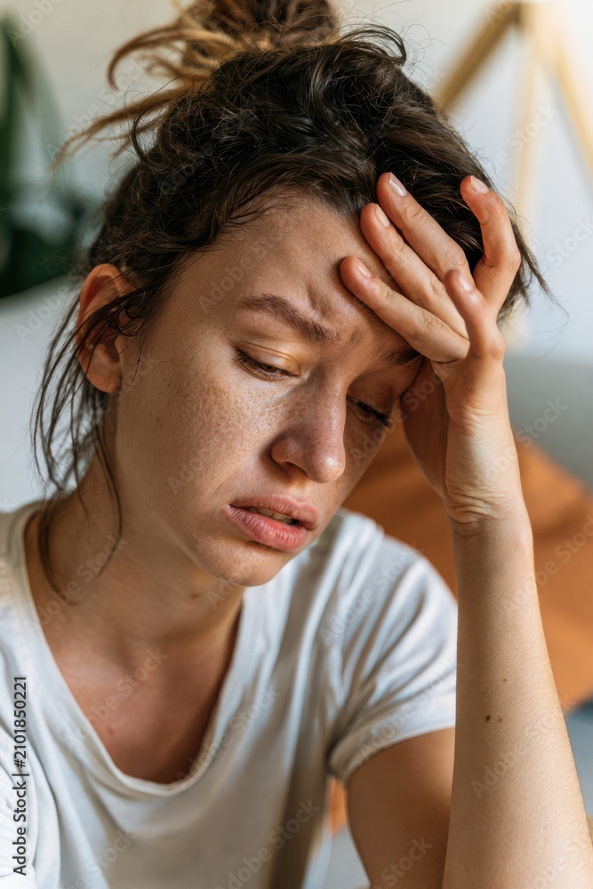 Fototapeta premium Female Experiencing Stress and Head Pain Indoors