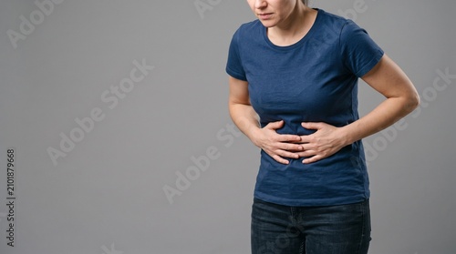 Woman suffering from stomach pain and abdominal discomfort