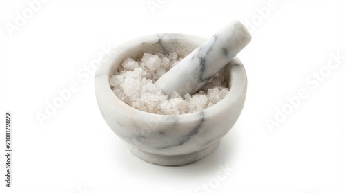 White marble mortar and pestle filled with coarse sea salt crystals for cooking