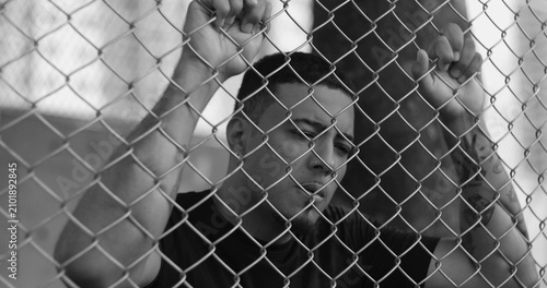 Konstfotografi Latin Hispanic man of African descent striking fence in anger and frustration, e