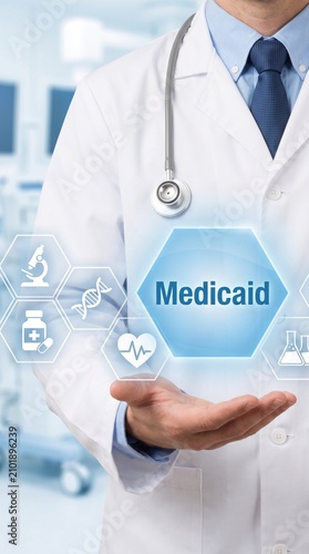 Doctor holding digital Medicaid interface. Medical professional using virtual health tech.