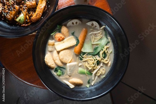 Картината върху платно Aromatic Noodle Soup: A steaming bowl of rich noodle soup, brimming with fresh vegetables, tofu, and savory broth, offering a comforting and delicious culinary experience