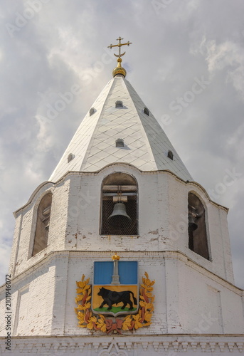 The bell tower of the Syzran Kremlin with the coat of arms of the city on the facade