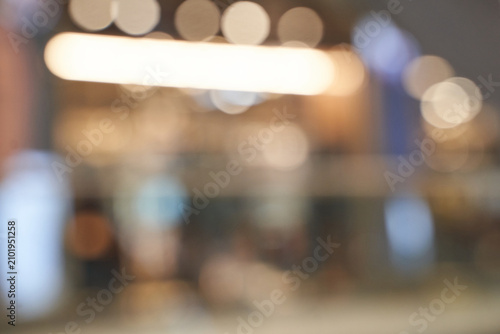 Bild auf Leinwand Mall Interior Lights Blurred In Wide Shallow Focus With Bokeh Highlights And Indistinct Storefronts Conveying Ambient Evening Atmosphere In Public Shopping Concourse