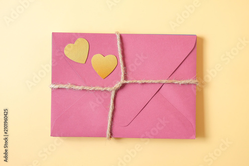 A Stack of Color envelopes tie with hemp rope on background.