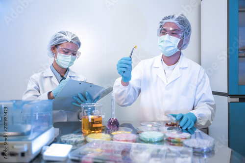 Female and male chemists performing drug discovery test and recording observation science facility. Research and development of supplements facts, Analyzing samples pharmaceutical laboratory.