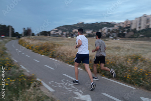 Men jogging in the evening. Motion blur.