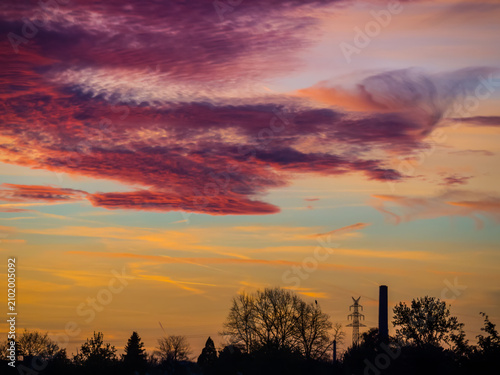 Crimson clouds in a yellow-blue sky at sunset
