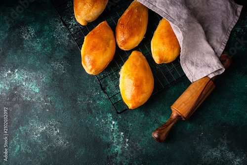 Fotografija Traditional baked pies pirozhki with meat.