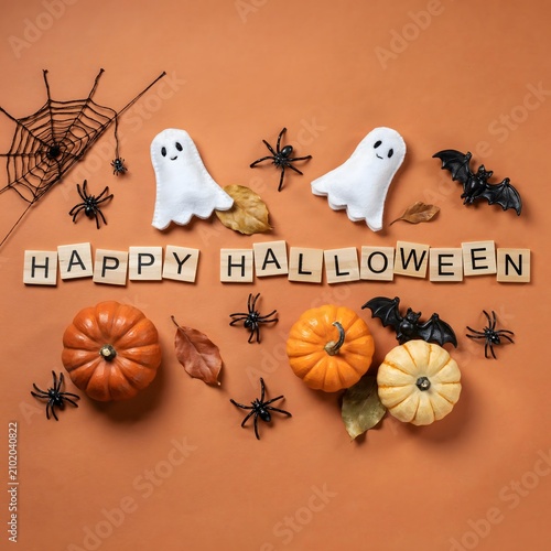Festive halloween still life with pumpkins ghosts and spiders on a warm orange background