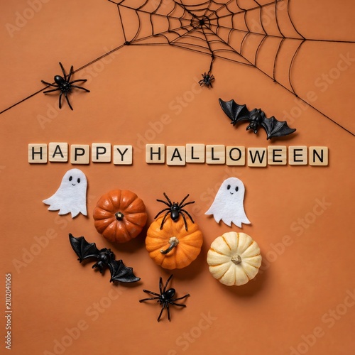 Halloween decorations with pumpkins ghosts spiders and bats on orange background