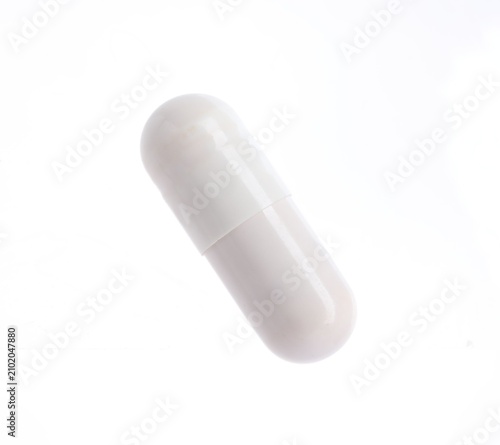 One pill on white background. Health supplement