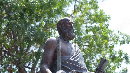 A statue of Hippocrates surrounded by trees in slow motion 60fps