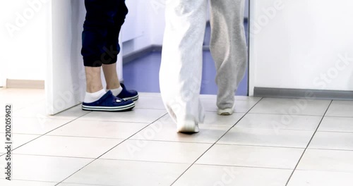 leaving after a doctor's appointment and the next client entering a modern medical facility.
