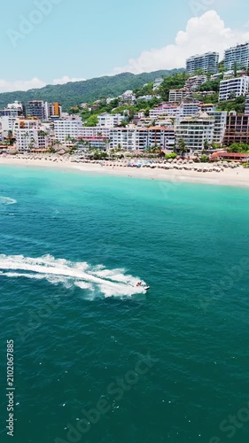 Speedboat cruising along puerto vallarta coastline in mexico