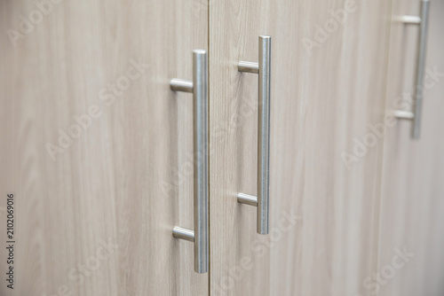 Metal handles on the cabinet doors in the room.