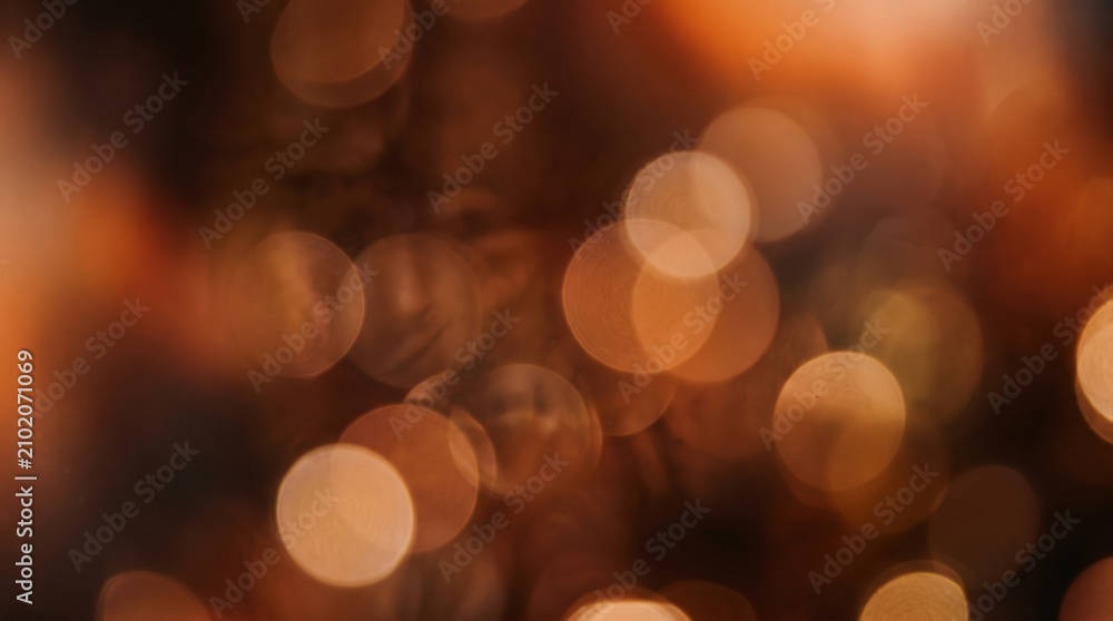 Fototapeta premium Abstract background with soft golden bokeh lights, festive holiday atmosphere, blurred warm glowing circles, elegant light effect