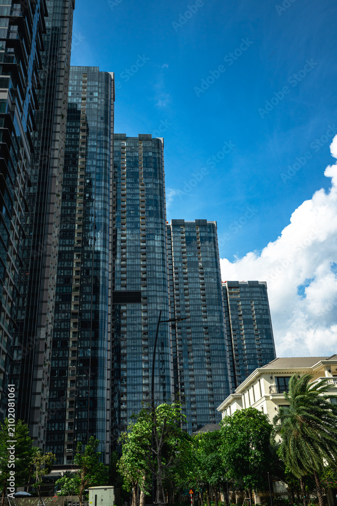 Fototapeta premium Low-angle architectural view of modern dark glass skyscrapers at 2 Ton Duc Thang development, Ho Chi Minh City, Vietnam
