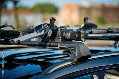 Konstfotografi Close up of an empty black bicycle roof rack mounted on a modern car on a sunny day