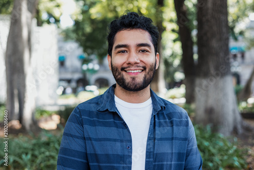 portrait of young latin man in public park in Mexico Latin America