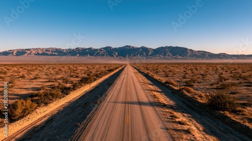 Endless desert highway through Imperial County, California under a clear blue sky