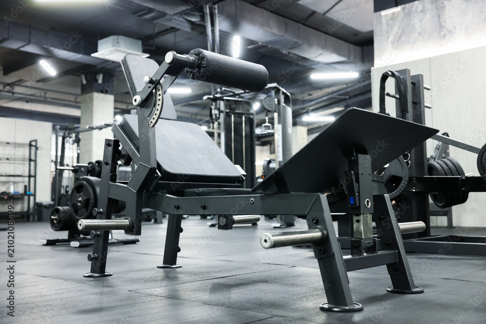 Obraz premium Exercise machines and weight plates in modern gym, low angle view