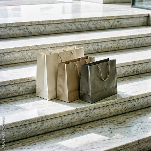 Paper Shopping Bags on Sunlit Marble Stairs