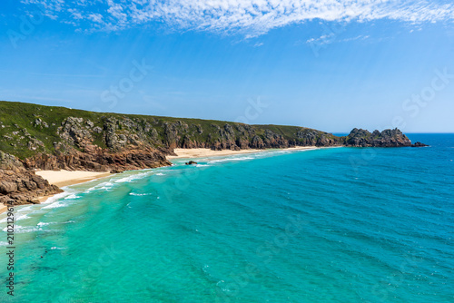 Coastal landscape with turquoise water and rocky cliffs in Cornwall, UK.