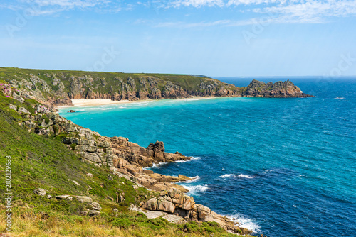 Coastal landscape with turquoise water and rocky cliffs in Cornwall, UK.