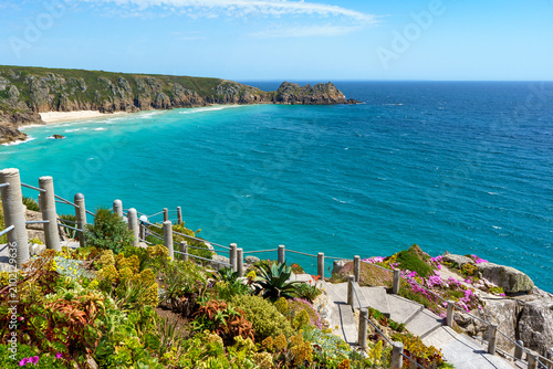 Coastal landscape with turquoise water and rocky cliffs in Cornwall, UK.