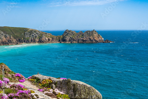 Coastal landscape with turquoise water and rocky cliffs in Cornwall, UK.