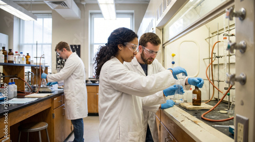 University students conducting chemistry experiments in lab setting  
