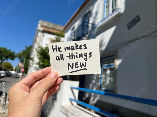 He makes all things new - christian lettering in the hand, biblical faith concept