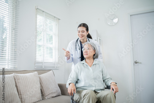 Obraz na plátně Friendly medical staff providing consultation and attentive care to elderly Asia