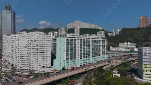 July 11 2026 Tall manufacturing factories line dense urban city streets.