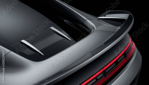Detailed image of an open trunk spoiler, tinted windows, and chrome accents.