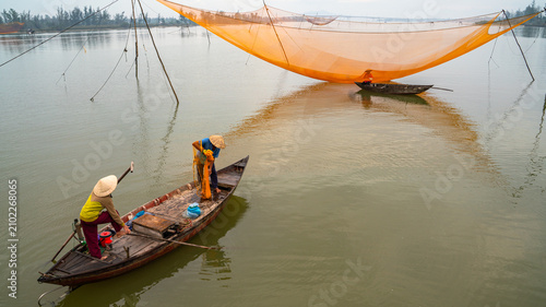 Bild auf Leinwand Early morning of a fisherman fishing in Cua Dai, Hoi AN