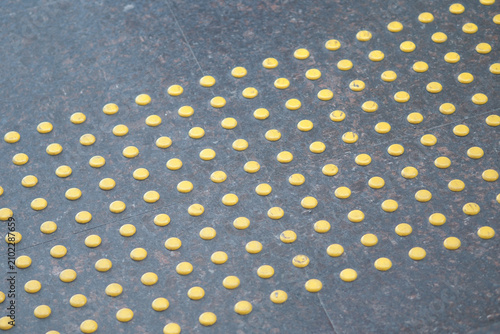 Принти на полотні Yellow tactile paving on a sidewalk for safety guidance
