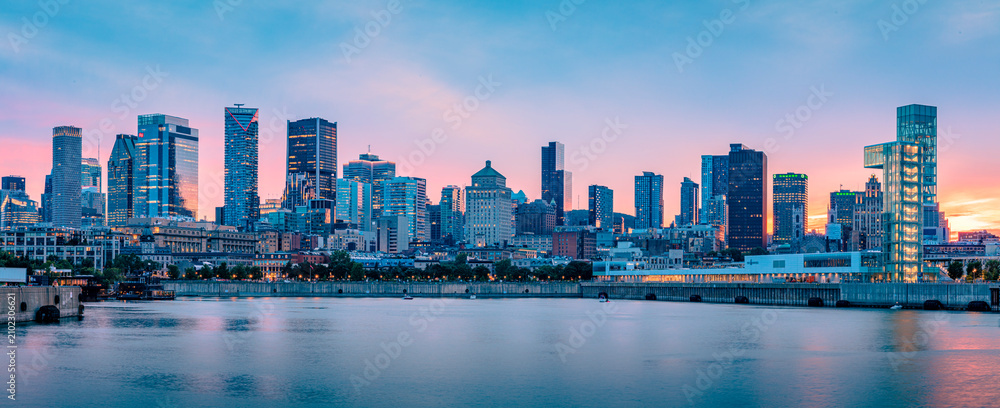 Naklejka premium Panoramic view of the Montreal skyline at dusk from the Old Port, downtown skyscrapers along the Saint Lawrence River waterfront, Quebec, Canada