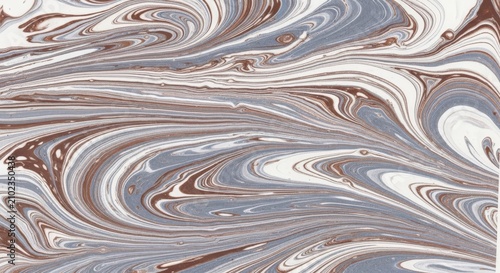 Abstract marbled paper texture with swirling patterns of white, slate blue, and earthy brown liquid paint colors