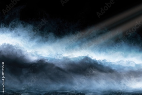 Misty Layers of Light Beams Over a Dark Landscape at Sunset